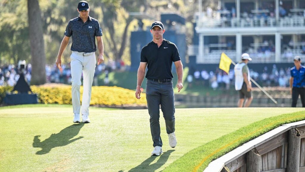 Rory McIlroy (right) and Jordan Spieth (left) walk off the 17th green at TPC Sawgrass