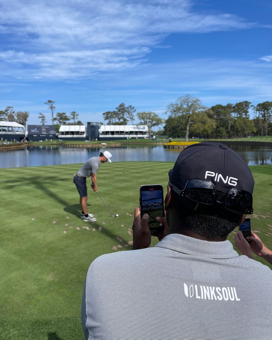 Sahith Theegala watches his caddie tee it up in the Caddie Competition.