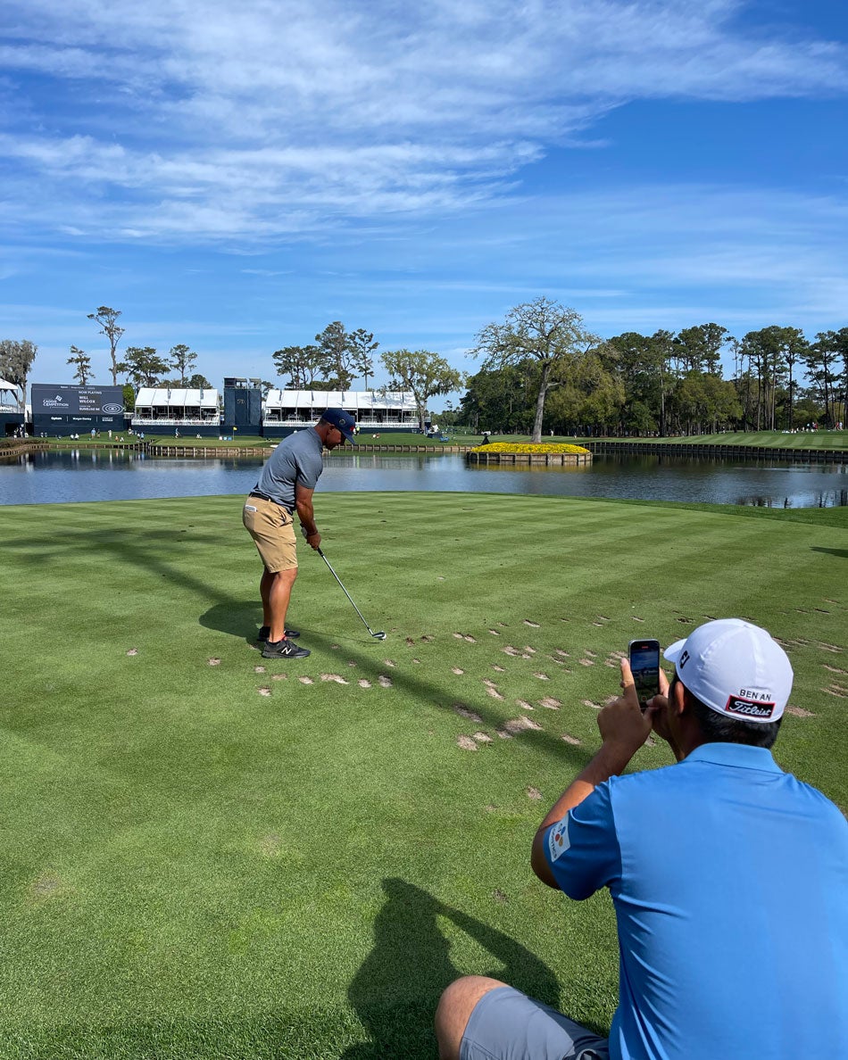 Ben An watches his caddie tee it up in the Caddie Competition.