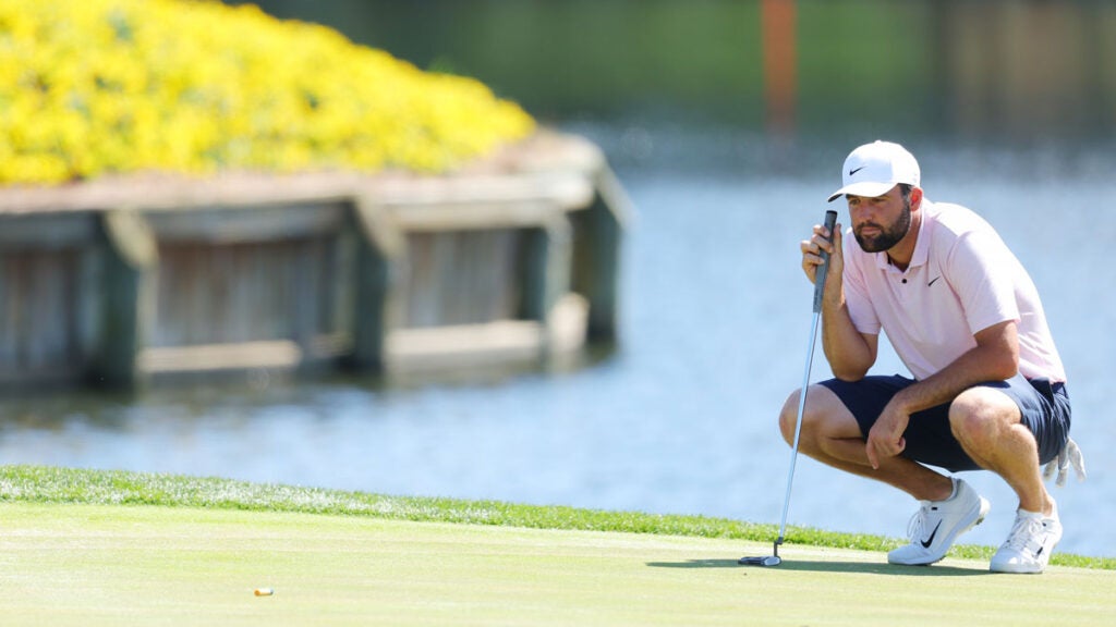 Scottie Scheffler of the United States lines up a putt on the 17th green during a practice round prior to THE PLAYERS Championship on the Stadium Course at TPC Sawgrass on March 12, 2024 in Ponte Vedra Beach, Florida.