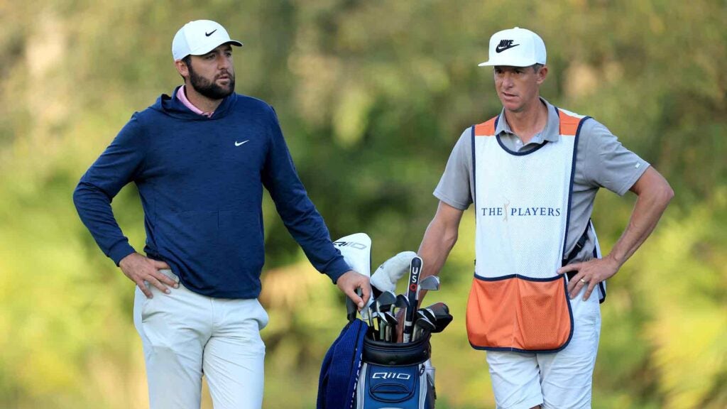 Scottie Scheffler of The United States prepares to play his second shot on the 10th hole with his caddie Ted Scott during the second round of THE PLAYERS Championship on the Stadium Course at TPC Sawgrass on March 15, 2024 in Ponte Vedra Beach, Florida.