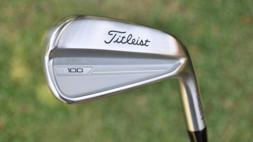 A Titleist T100 iron back bar pictured on a golf course