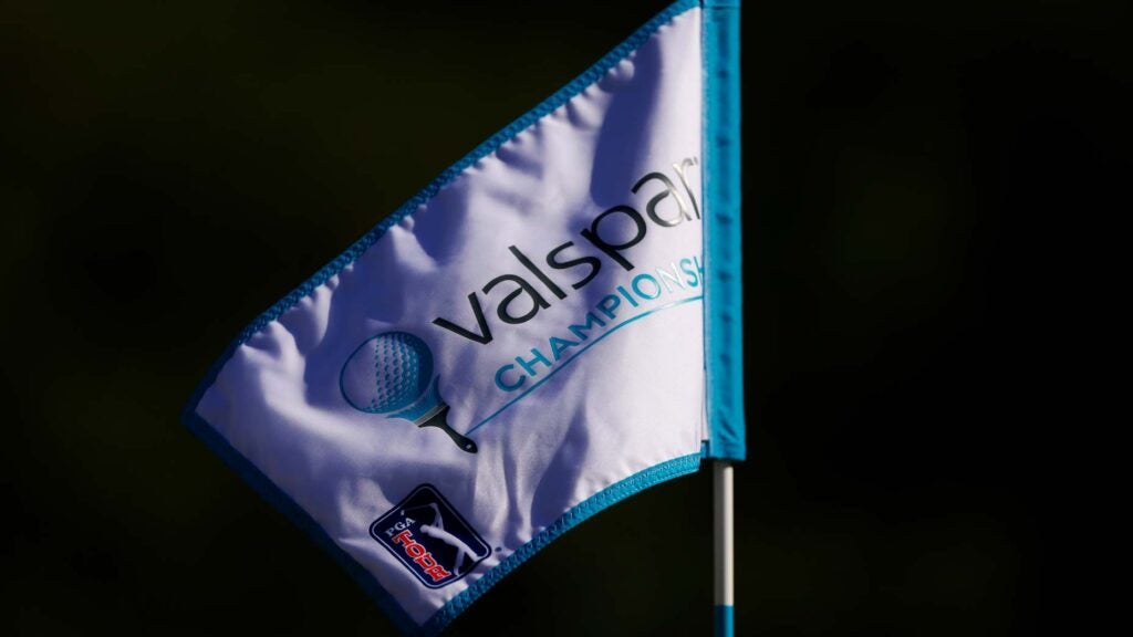 A 2024 Valspar Championship pin flag blows in wind at Innisbrook Resort