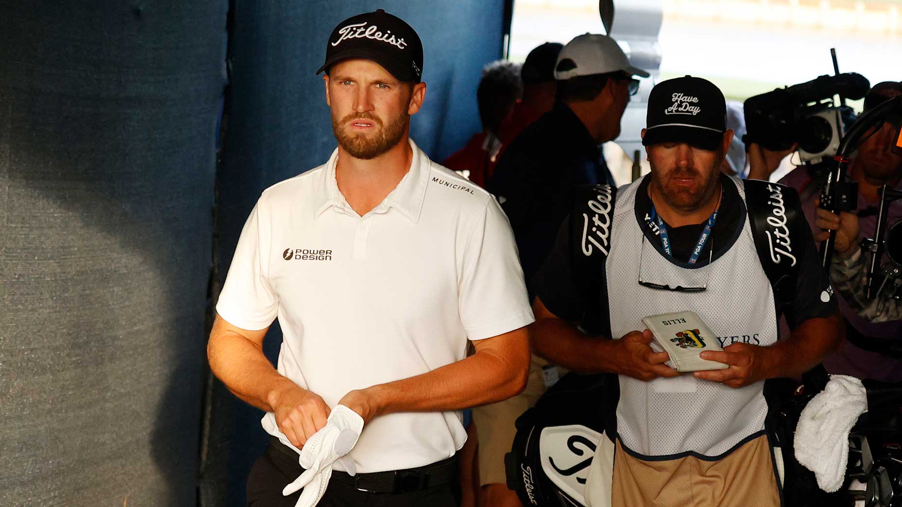 PGA Tour pro Wyndham Clark walsk by granstands with caddie at 2024 Players Championship