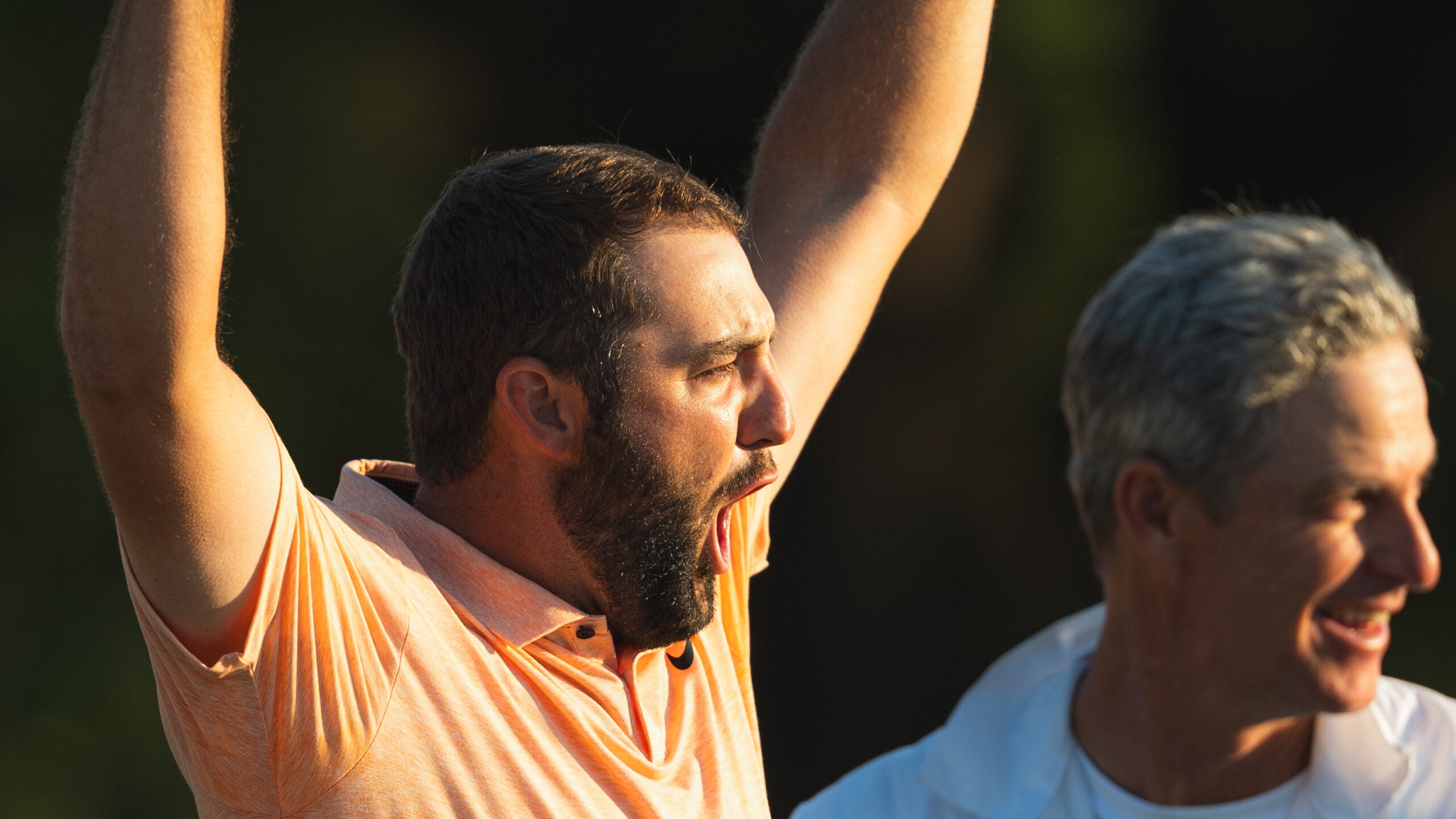 scottie scheffler screams in victory at the Masters in orange shirt