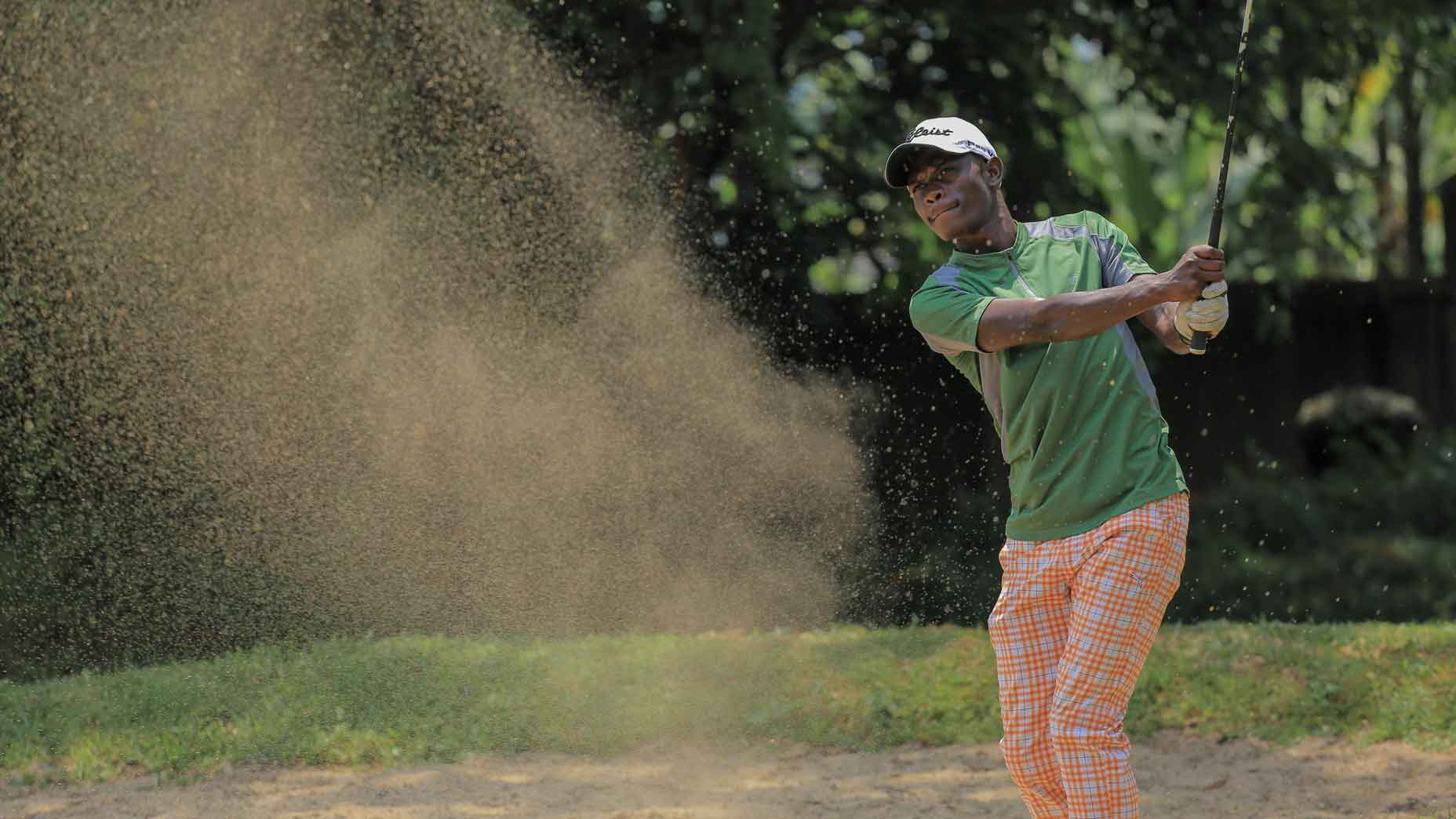 Isaiah Mwesige playing a bunker shot at Toro golf club in Urganda