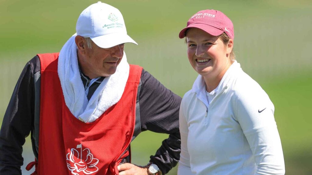Lottie Woad of England smiles with her caddie after finishing her round on the 18th hole during the second round of the Augusta National Women's Amateur at Champions Retreat Golf Course on April 04, 2024 in Evans, Georgia.