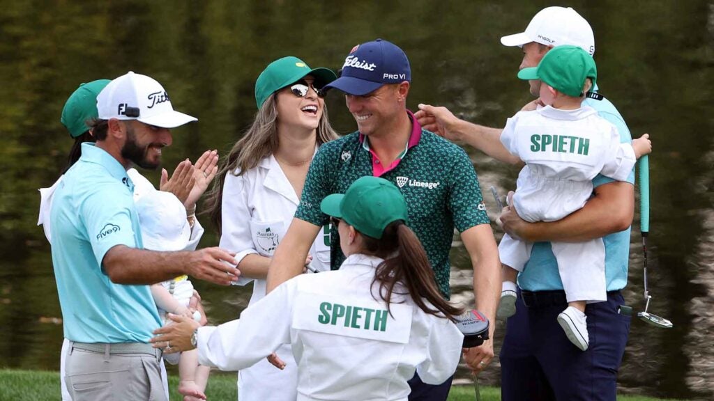 Max Homa hugs Annie Spieth and Justin Thomas of the United States on the ninth green during the Par 3 contest prior to the 2023 Masters.