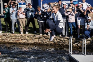 Nelly Korda jumps in a pond.