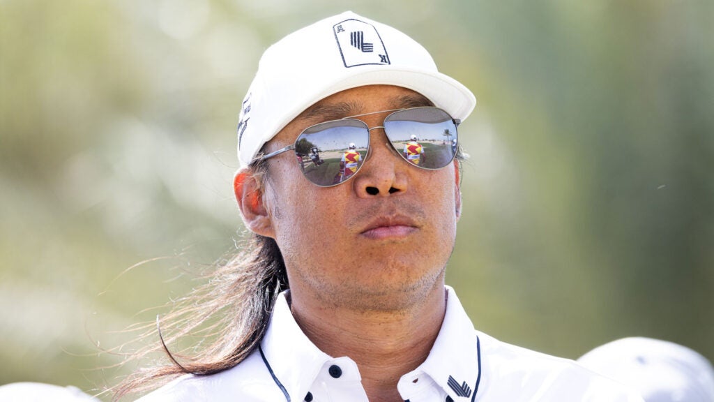 Pro golfer anthony kim wears sunglasses and stares into space