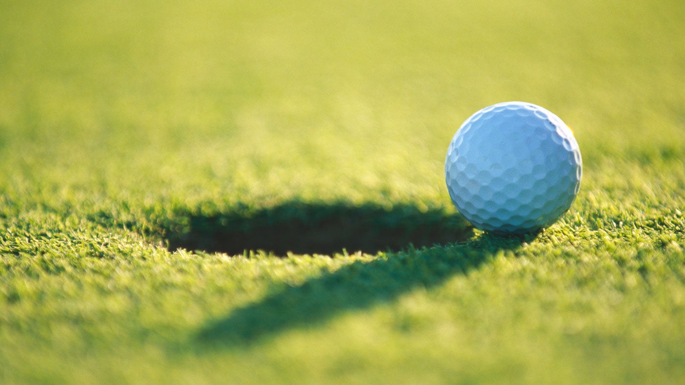 golf ball on edge of hole