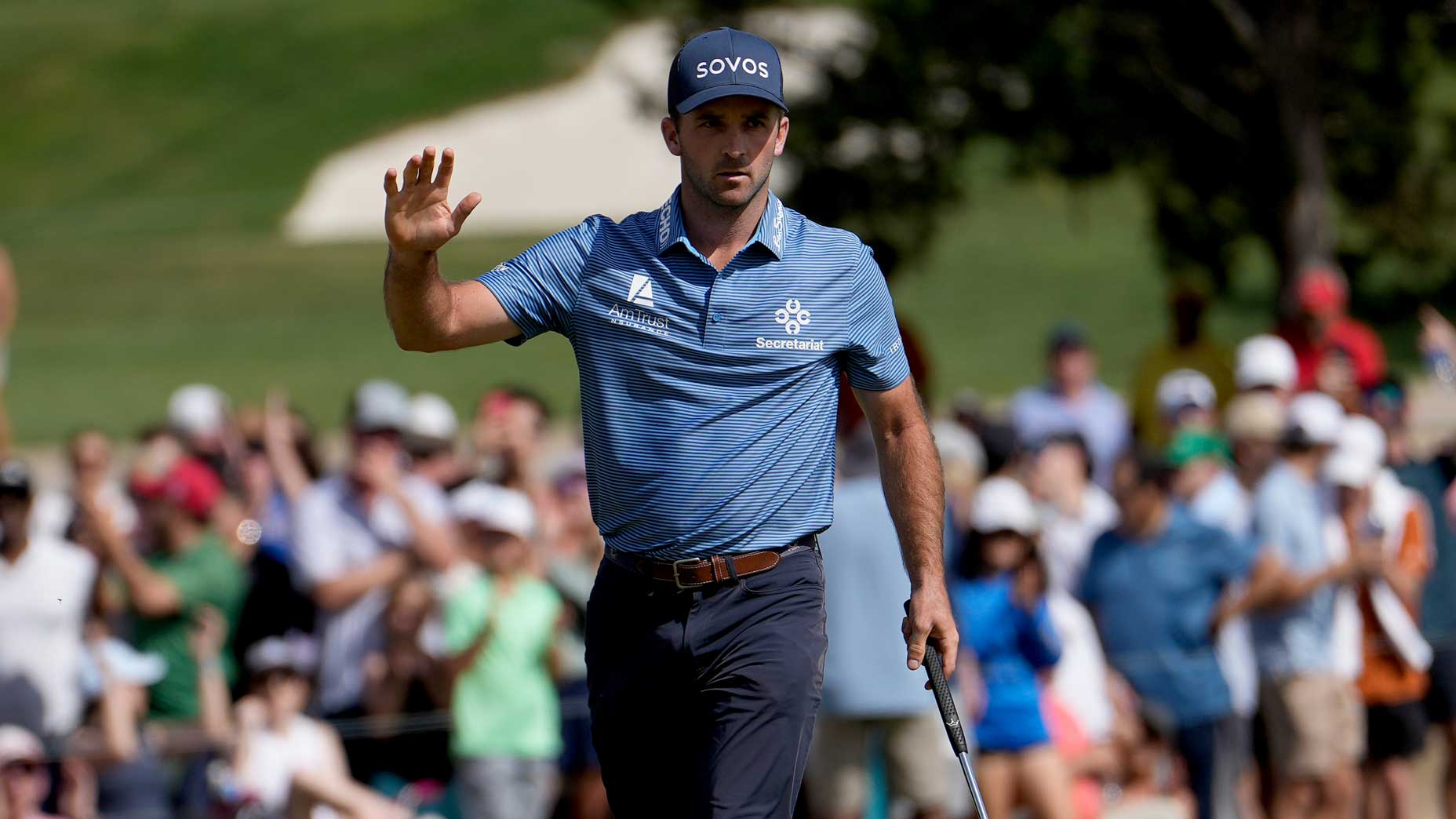 Pro golfer Denny McCarthy waves to crowd on green at 2024 Valero Texas Open