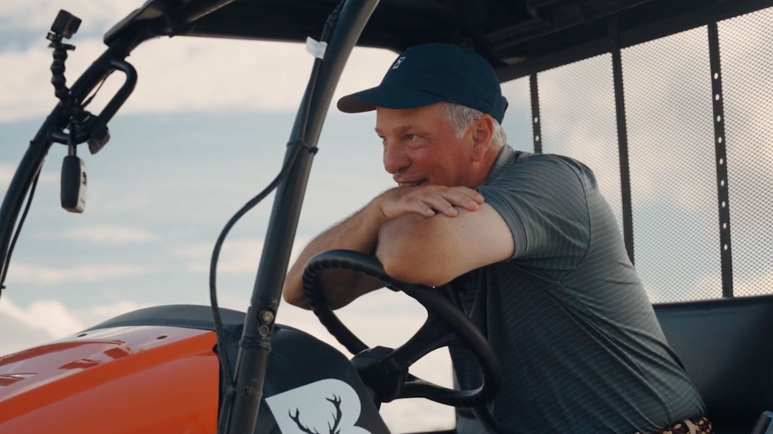 tom doak sitting in a tractor