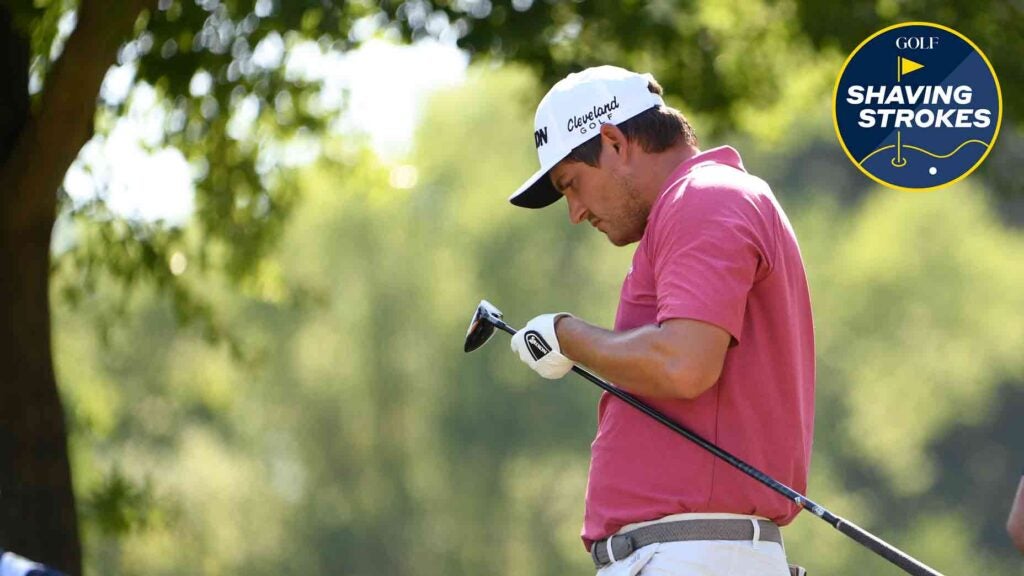 Pro golfer looks at his golf club during a PGA Tour tournament.