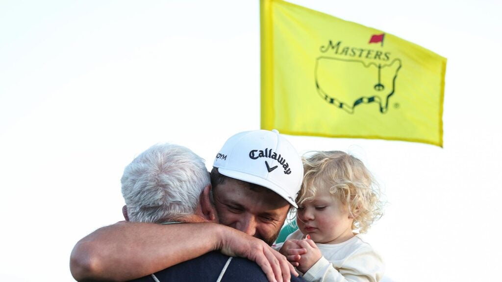 jon rahm hugs father and son at the Masters.