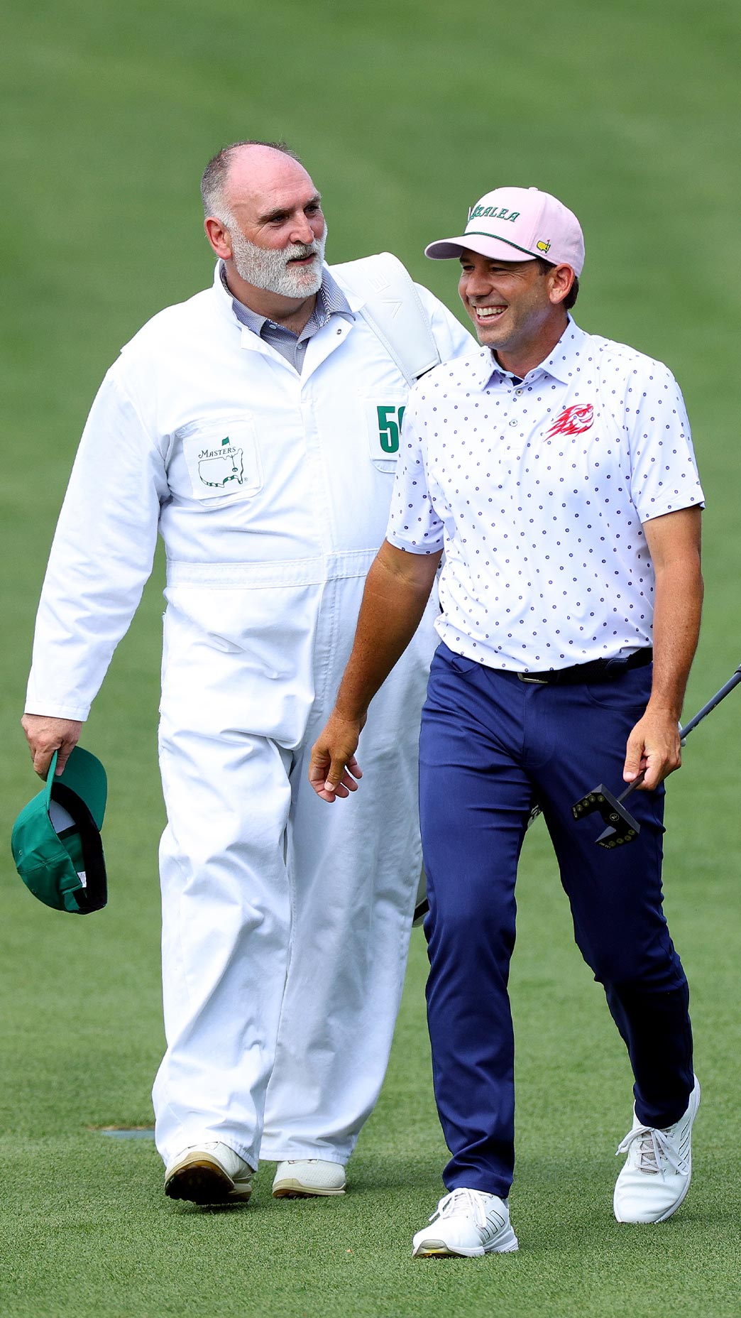 Jose Andres and Sergio Garcia walk at the Masters Par-3 Contest.