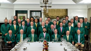 Past Masters champions pose with Jon Rahm in green jackets at the 2024 Masters Champions Dinner