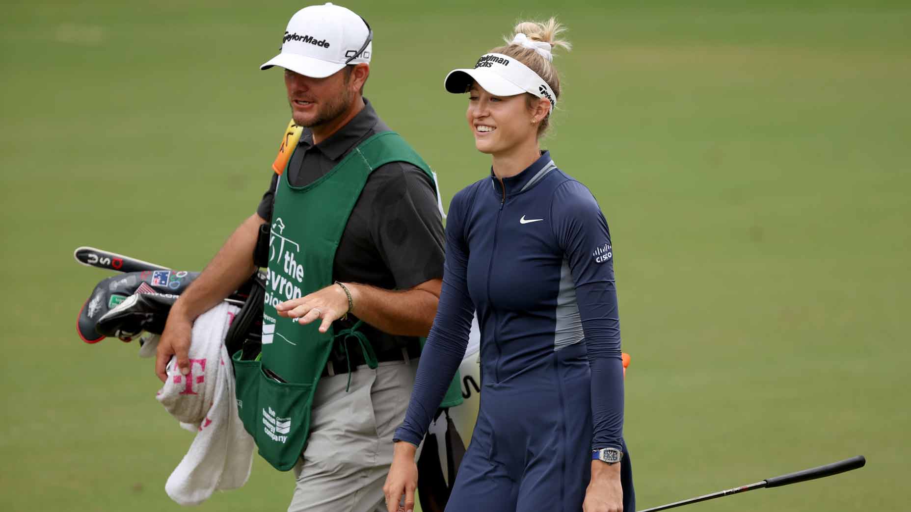 nelly korda smiles as she walks with her caddie during the third round of the chevron championship