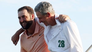 cottie Scheffler shares a moment and celebrates with his caddie Ted Scott after winning for the second time the Masters Tournament