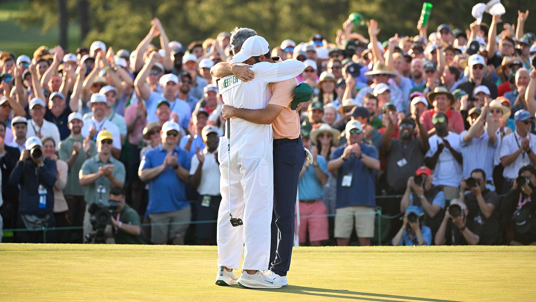 Scottie Scheffler and caddie Ted Scott hug following their 2024 Masters victory.