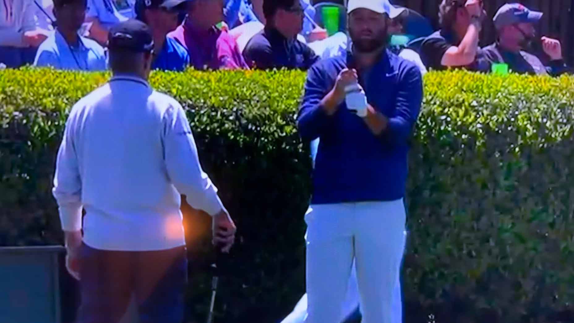 scottie scheffler checks his grip on the range at the 2024 masters