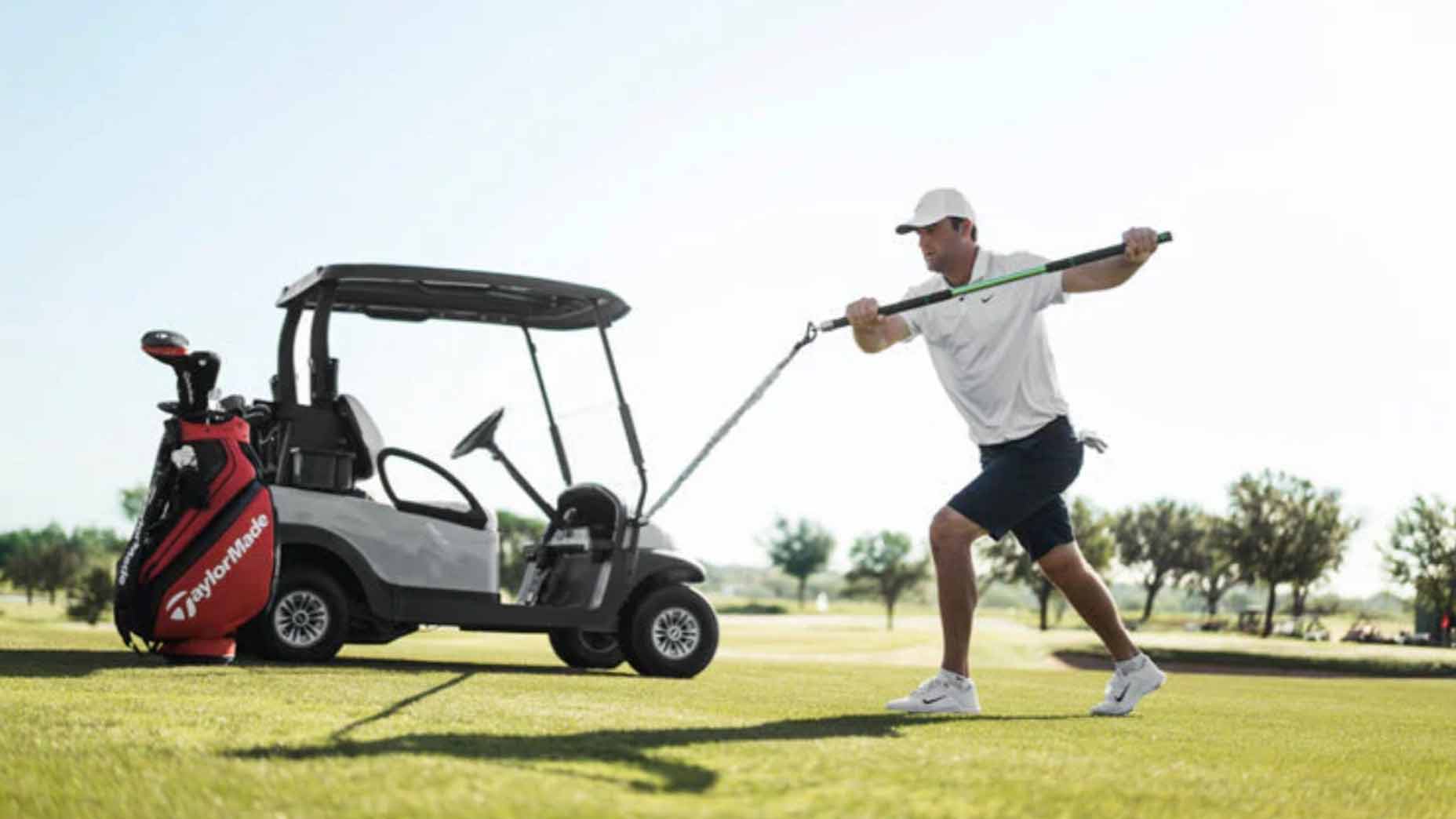 scottie scheffler uses the golf forever swing trainer attached to a golf cart