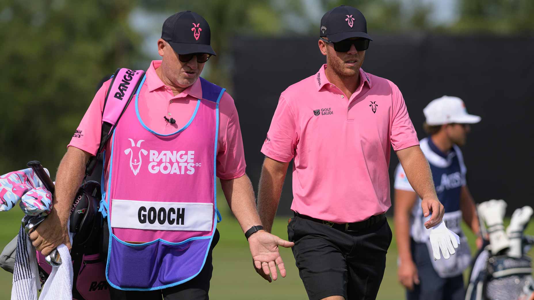 LIV Golf pro Talor Gooch walks with caddie at LIV Miami in 2023