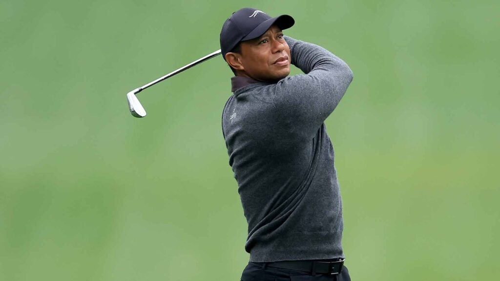 tiger woods swings during a practice round for the 2024 masters