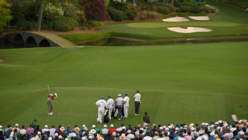 Tiger Woods hits a shot into the par-3 12th during the first round of the Masters on Thursday at Augusta National.