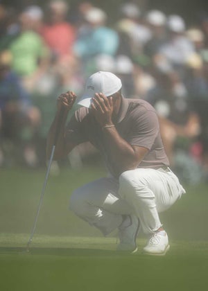 Tiger Woods shields his eyes