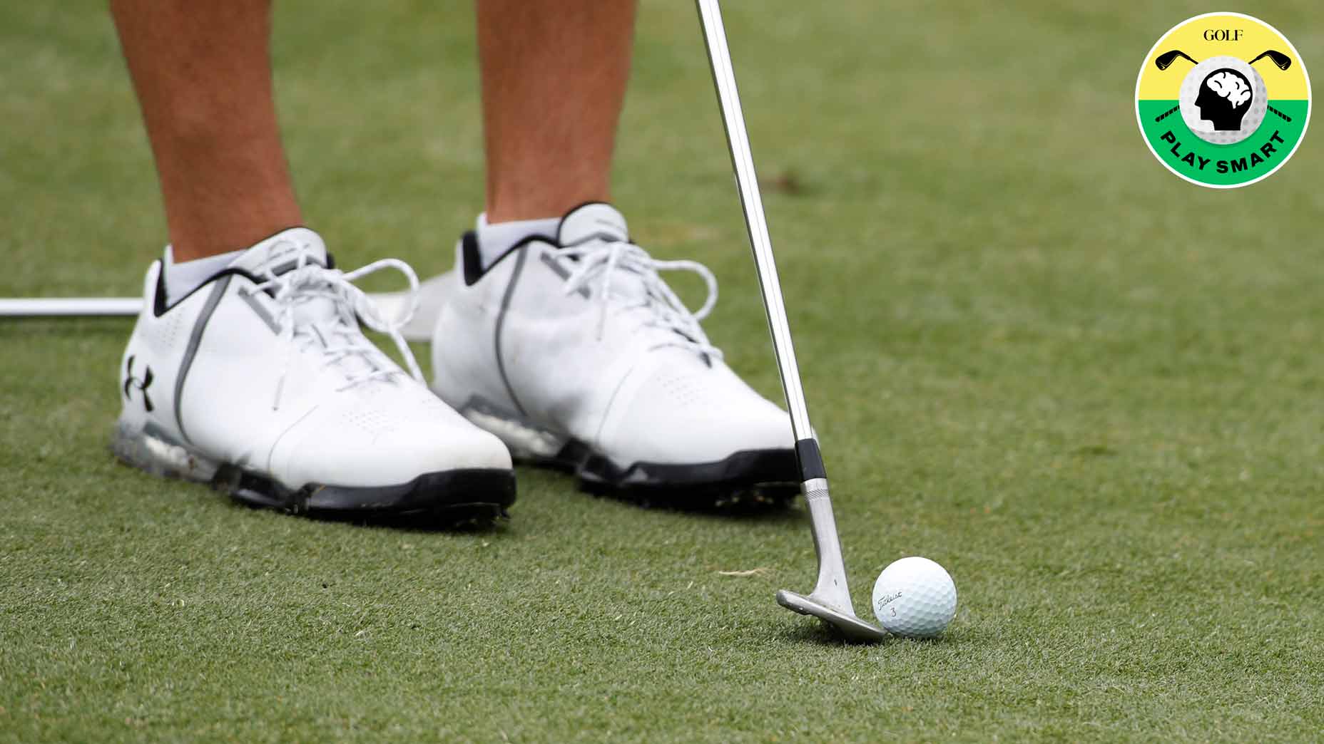 close-up of jordan spieth's wedge and golf ball next to his feet