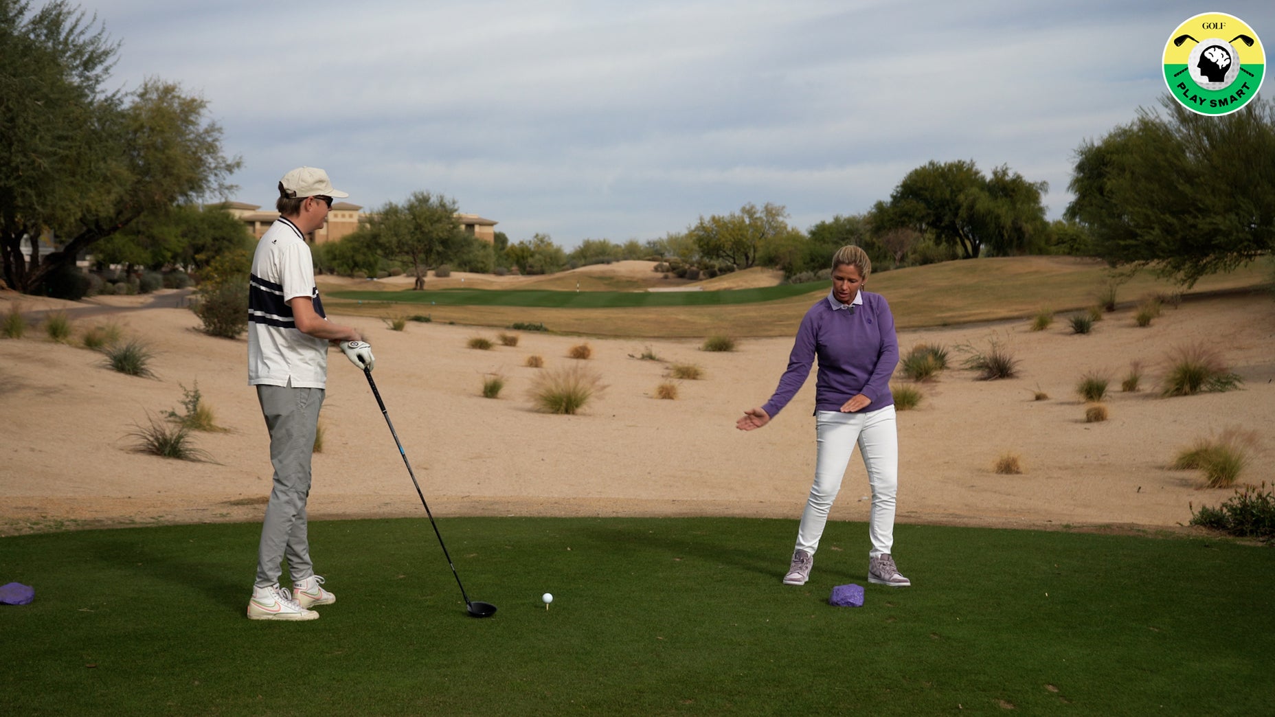 sarah stone demonstrates swing tip to GOLF editor zephyr melton on a tee box