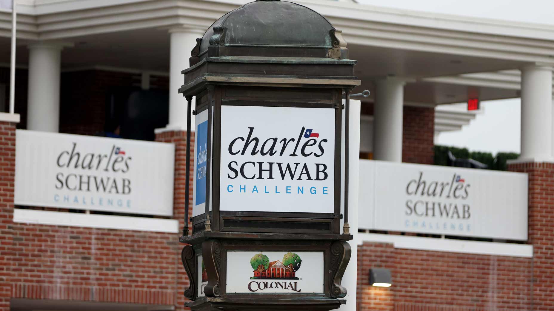 Colonial Country Club's clubhouse with 2024 Charles Schwab Challenge signs