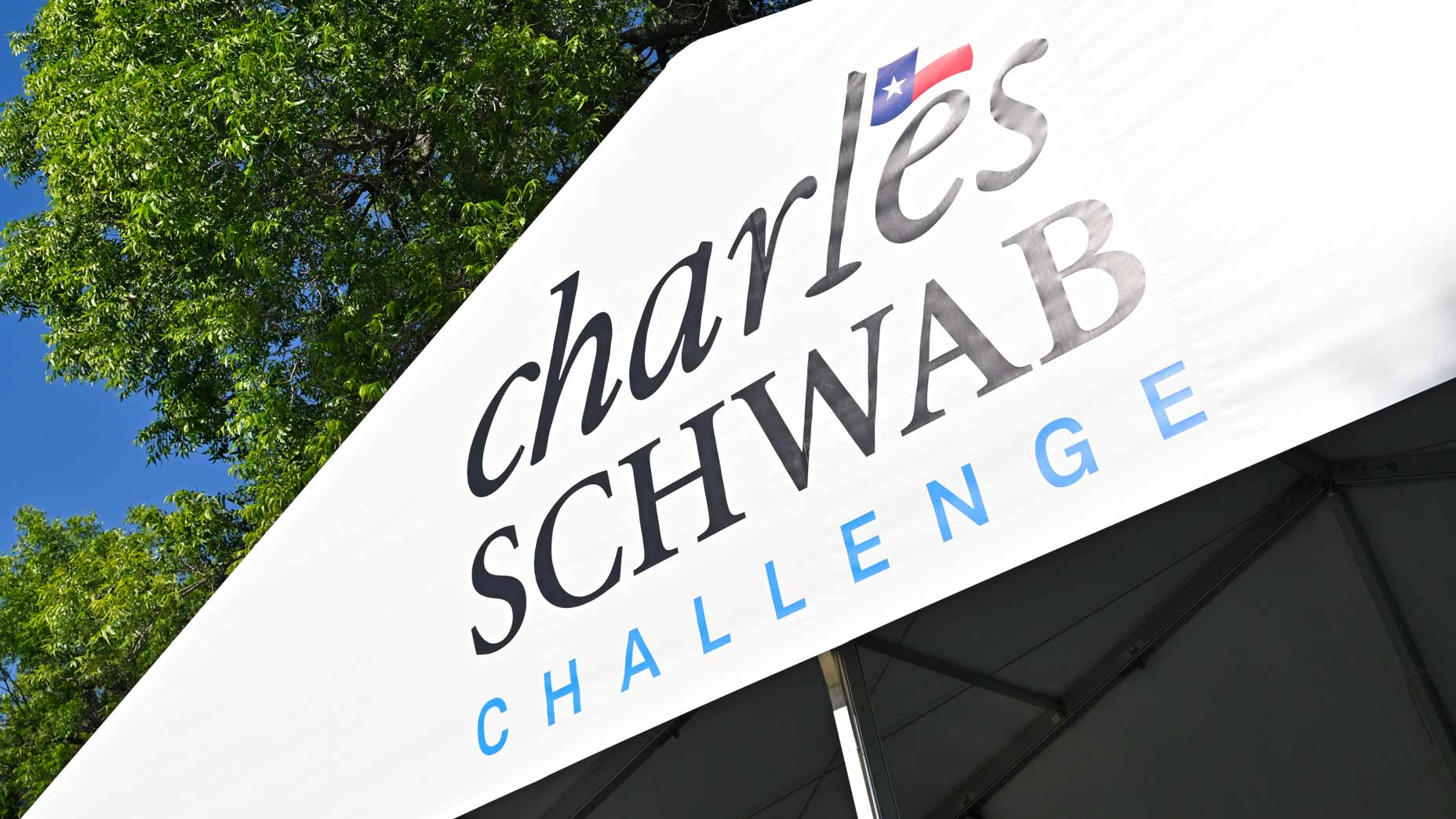 A Charles Schwab Challenge sign pictured on a tournament tent at Colonial