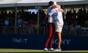 Grayson Murray hugs his caddie, Jay Green, after winning in a playoff at the 18th hole on the first playoff hole during the final round of Sony Open in Hawaii