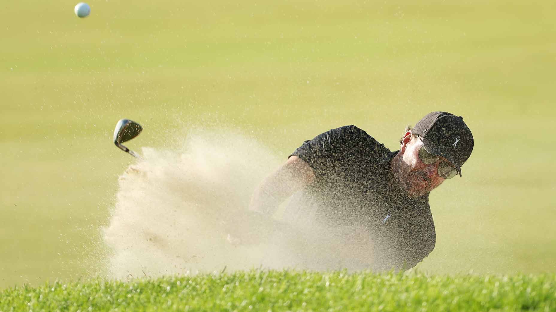 phil mickelson hits a bunker shot during the 2022 u.s. open