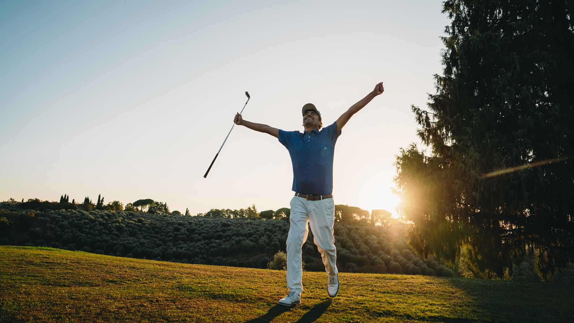 Hole-in-one celebration for a professional golfer. He's celebrating at sunset.