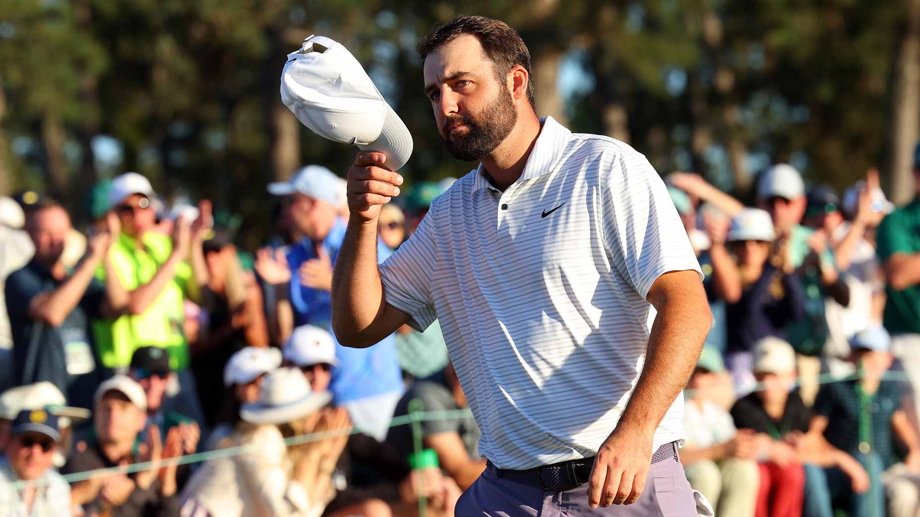 Pro golfer Scottie Scheffler tips his cap to fans at 2024 Masters