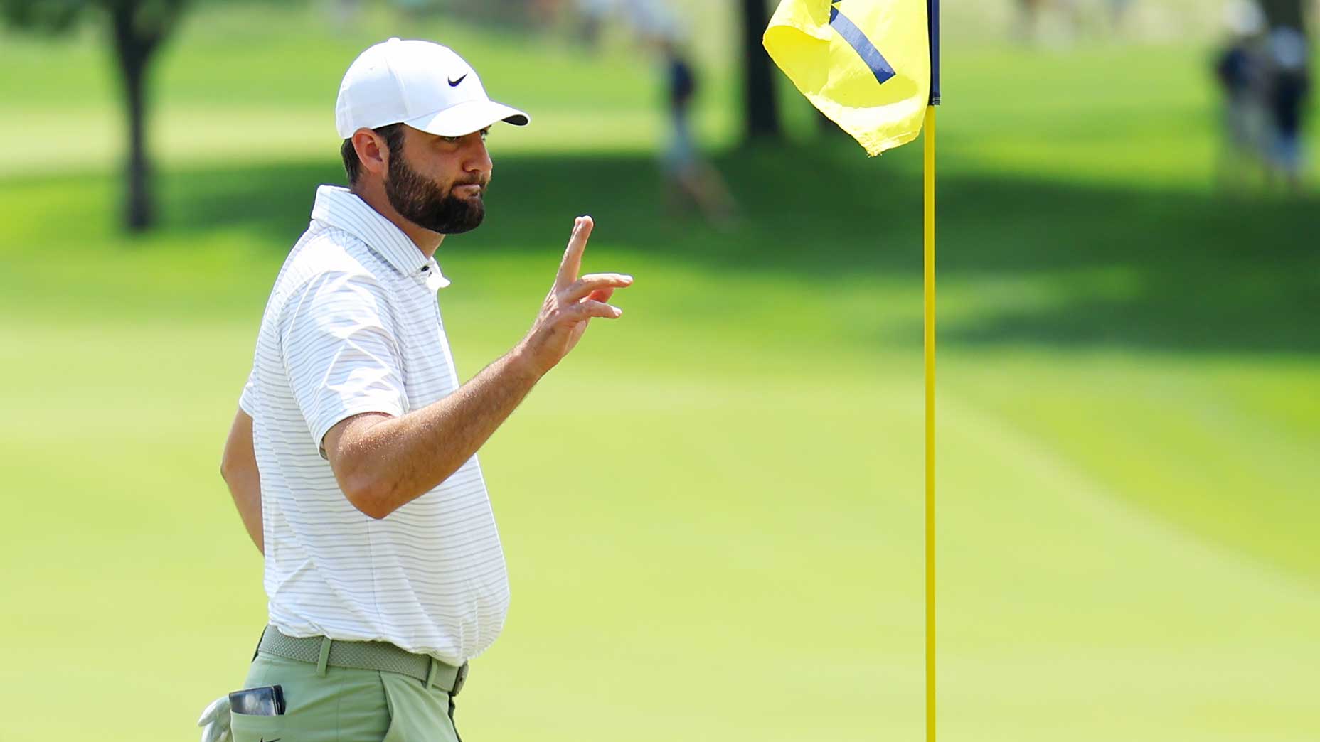 Scottie Scheffler acknowledges the crowd on the 1st green at Valhalla Golf Club on Thursday.