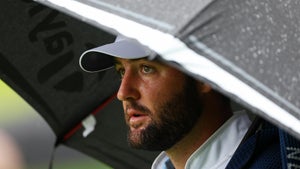 scottie scheffler stares from underneath umbrella at pga championship