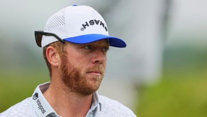 talor gooch stares at the PGA Championship in a white hat and blue shirt