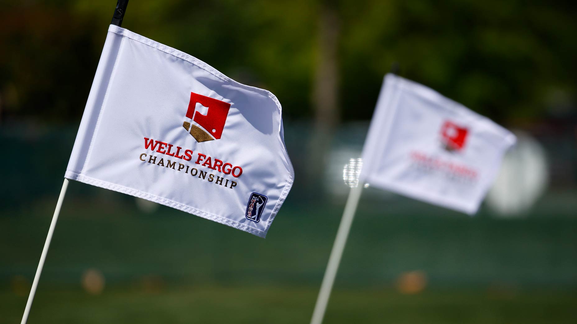 Two Wells Fargo Championship flags blow in breeze at Quail Hollow