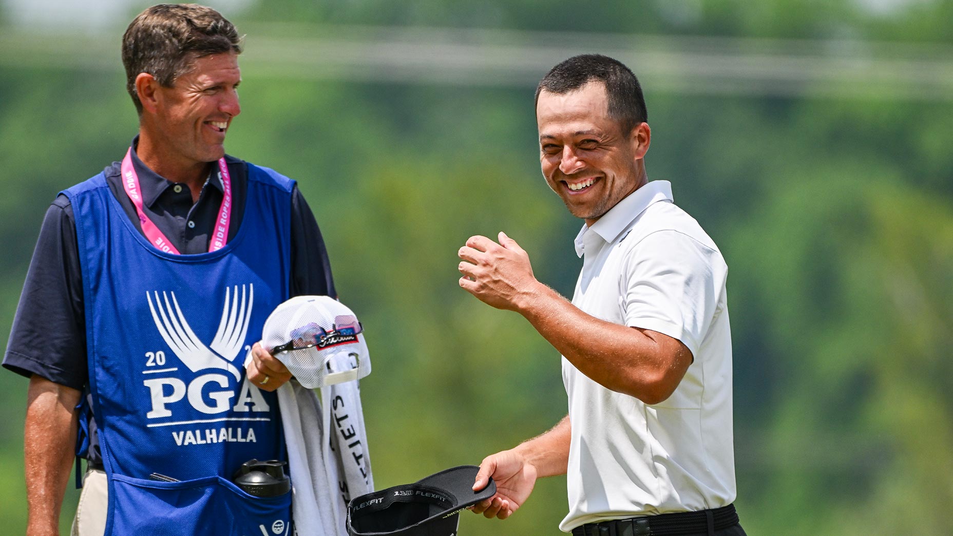 xander schauffele smiles at the PGA Championship next to caddie