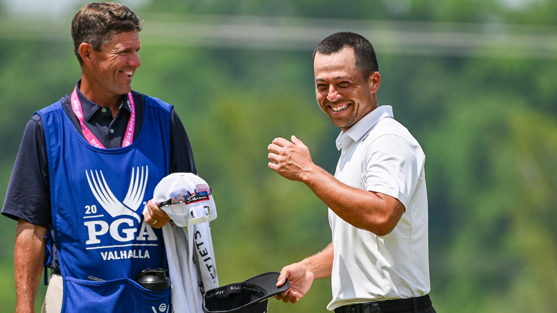 xander schauffele smiles at the PGA Championship next to a caddy