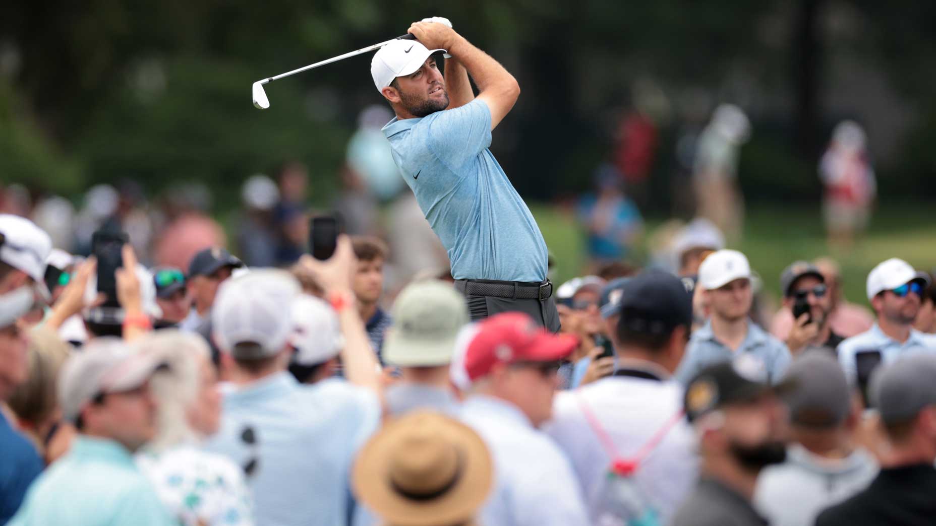 Scottie Scheffler plays a shot surrounded by a gallery at the Travelers.