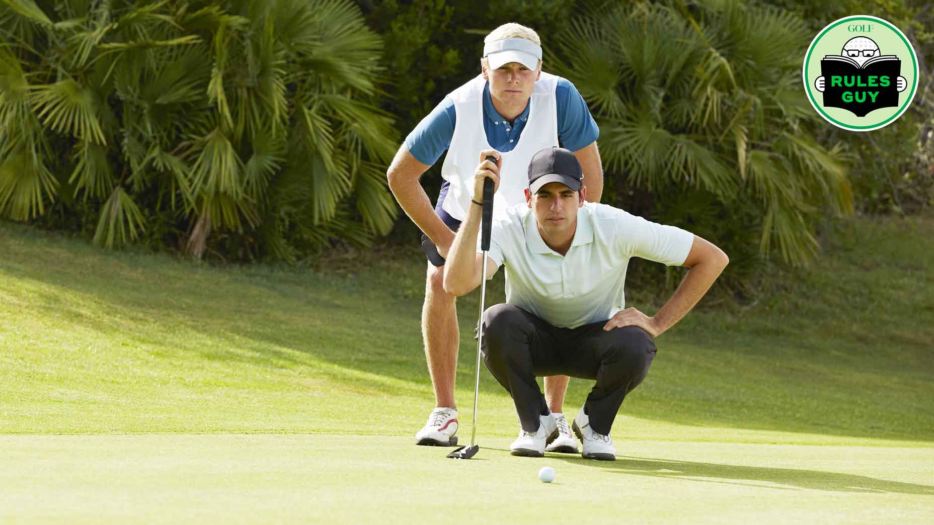 Caddie and player looking at a putt