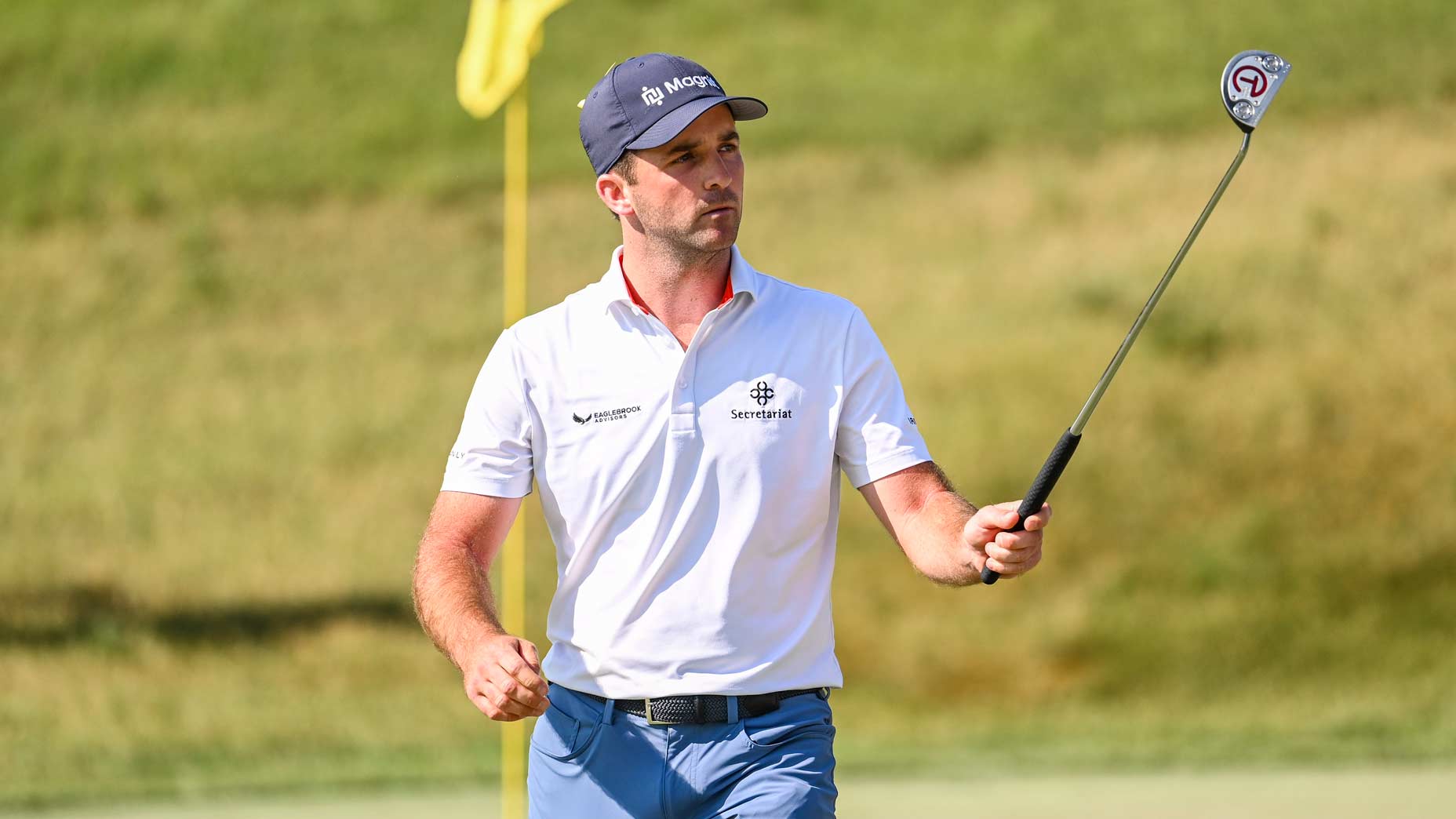 Professional golfer Denny McCarthy raises the green for fans at the 2023 Memorial Tournament