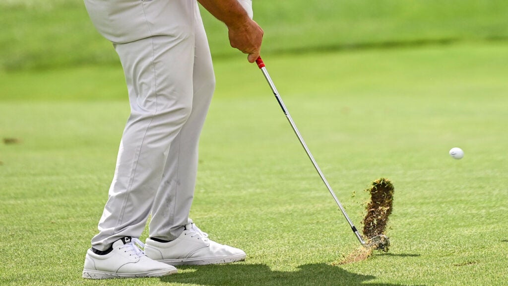 Jon Rahm of Spain makes a divot as he plays his second shot on the third hole fairway during the final round of THE NORTHERN TRUST,