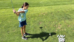 A young girl from Pine Ridge reservation practices her swing.