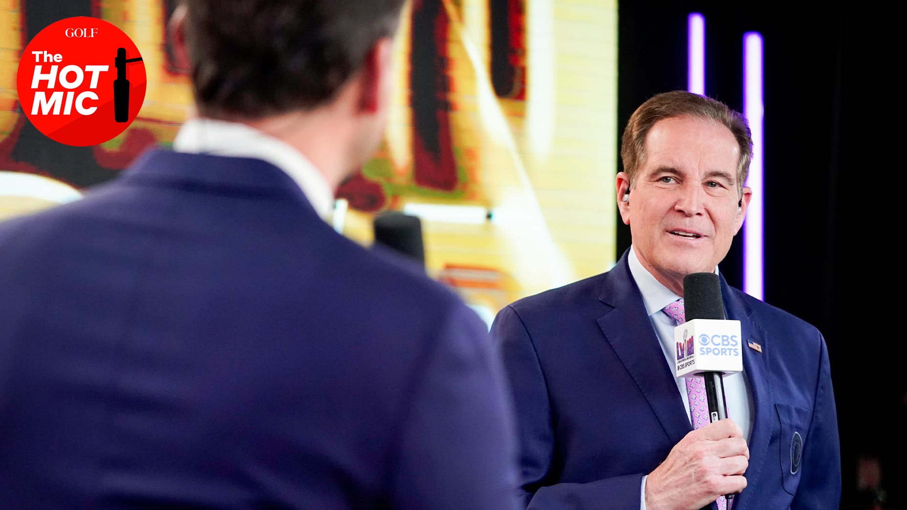 jim nantz stares at partner and speaks at the super bowl in suit